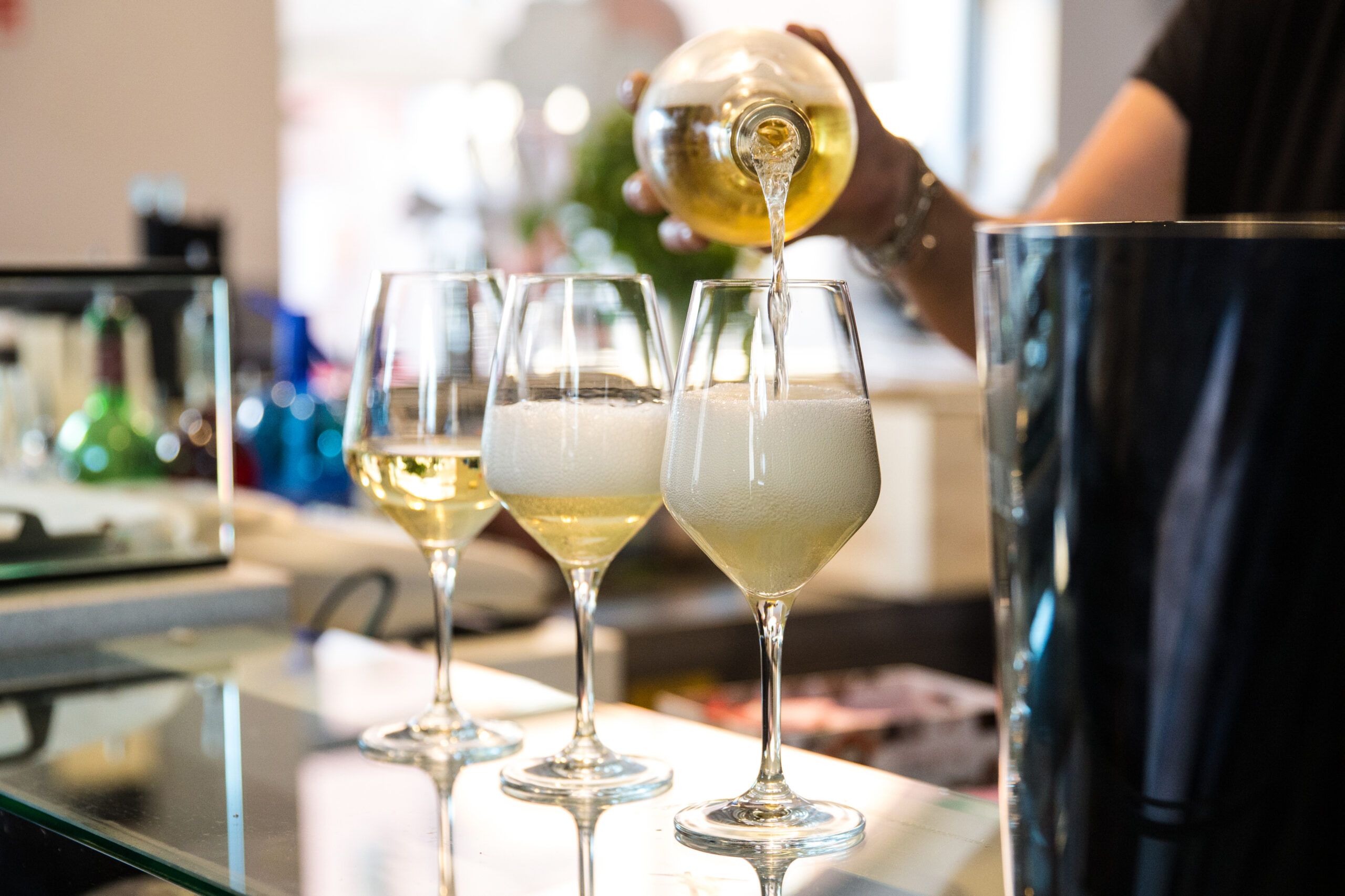 A,Barmaid,Is,Serving,Three,Glasses,Of,Prosecco,On,The Prosecco Spumante Franciacorta Trentodoc